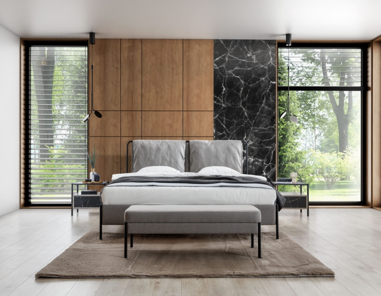 Nowoczesne łóżko z tapicerowanym wezgłowiem na lekkiej, metalowej konstrukcji. Miękkie poduszki, czarne nóżki i elegancki design tworzą wyjątkową sypialnię pełną komfortu.